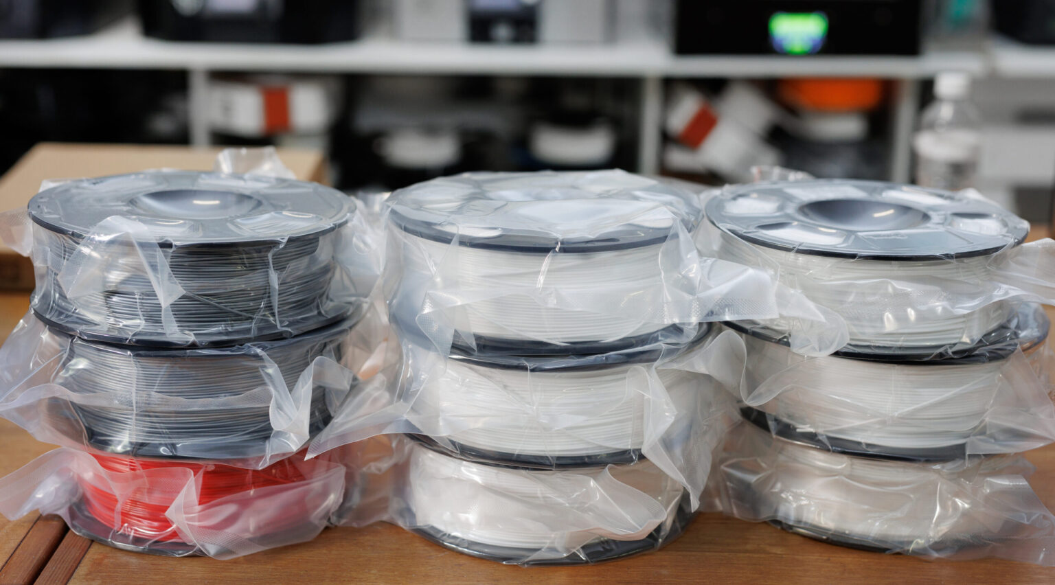 Stacks of vacuum-sealed PLA filament spools ready for dispatch